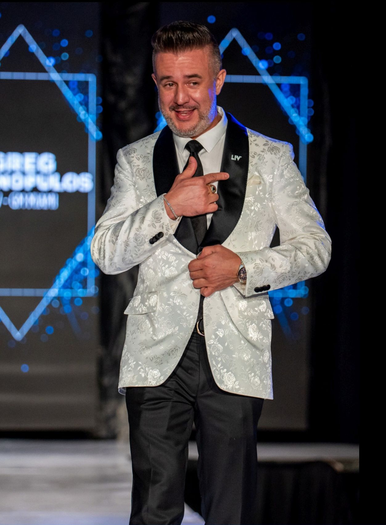 A model in a David Alan dinner jacket on the runway